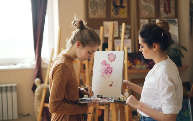 Two women painting in an art studio