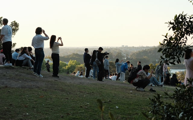 Woman picking up trash in the woods
